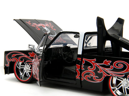 1985 Chevrolet C-10 Pickup Truck Black with White Top and Graphics with Charro Man Diecast Figure "Tapatio" 1/24 Diecast Model Car by Jada