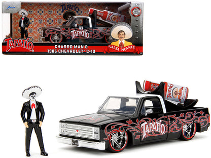 1985 Chevrolet C-10 Pickup Truck Black with White Top and Graphics with Charro Man Diecast Figure "Tapatio" 1/24 Diecast Model Car by Jada