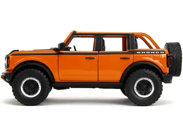 2021 Ford Bronco Open-Top Orange with Black Stripes and Hood with Extra Wheels "Just Trucks" Series 1/24 Diecast Model Car by Jada #3